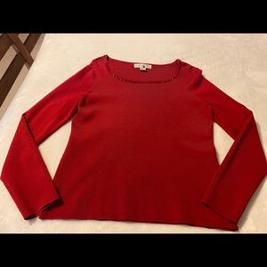 Fine size small red sweater with red bead accent at the neck.